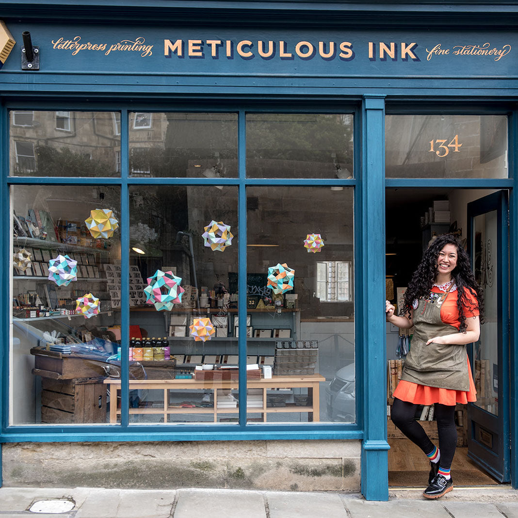 Classic shopkeeper picture of the front of the shop with shop owner Athena standing in the doorway