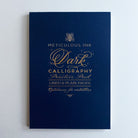Dark calligraphy practice pad with gold lettering