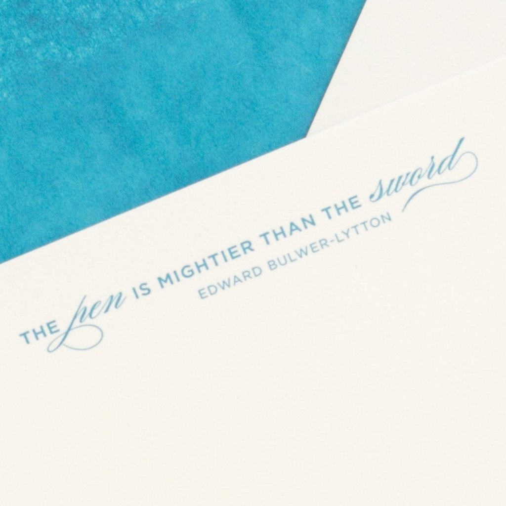 Close-up of letterpress quote blue The Pen is mightier than the Sword by Edward Bulwer-Lytton