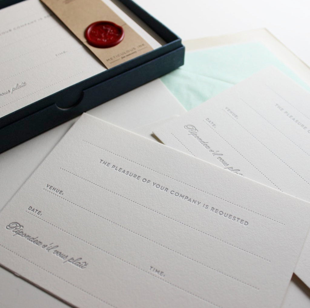 Letterpress Invitation Correspondence Cards scattered as singles and in box