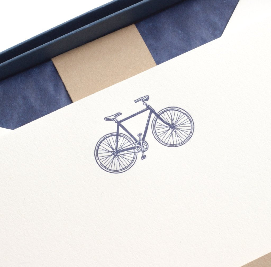 close-up of blue bicycle on letterpress letterhead