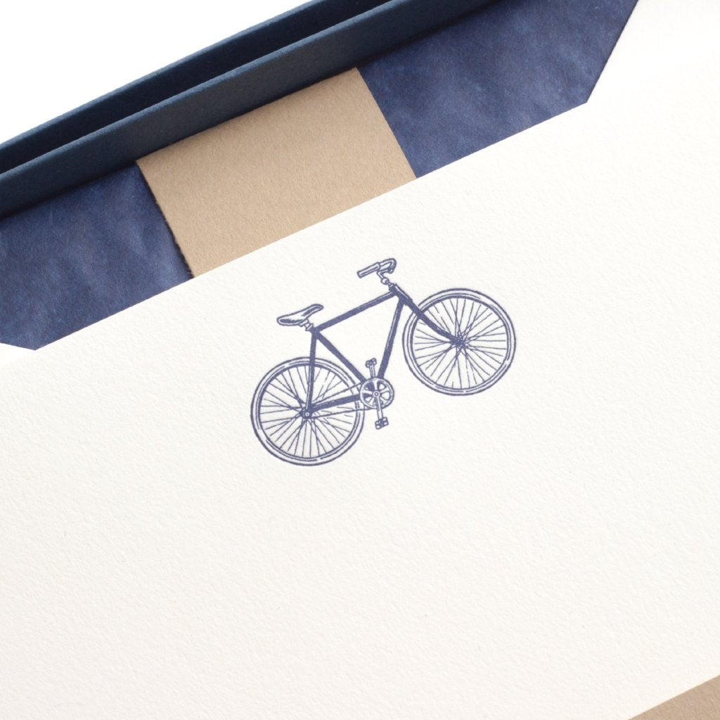 close-up of blue bicycle on letterpress letterhead