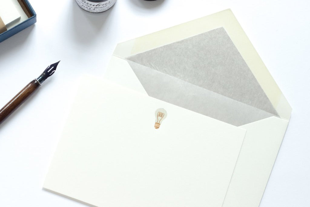 Lightbulb Letterpress Correspondence Card with grey tissue lined envelope and nib and ink pot