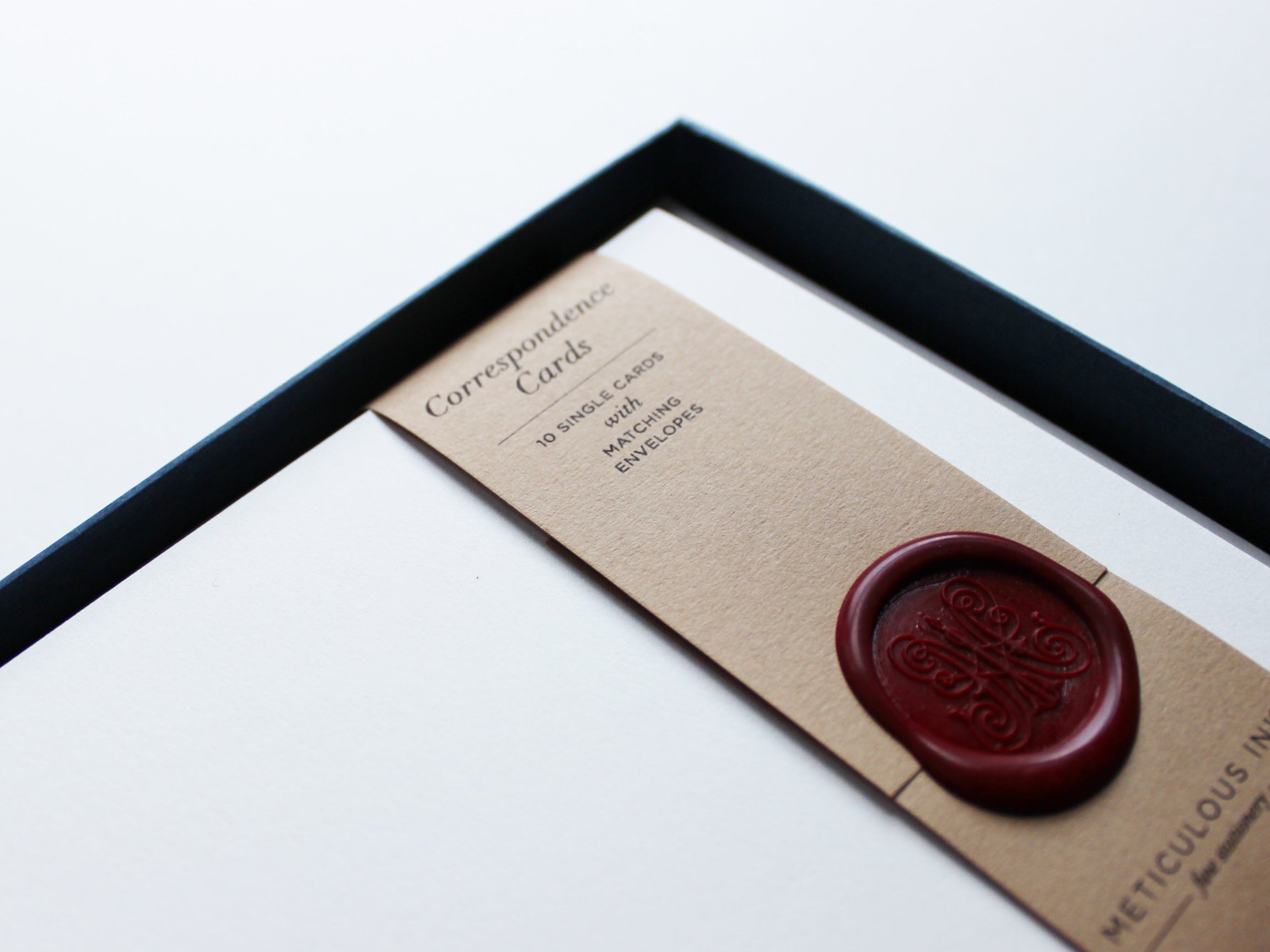 Close-up of plain Correspondence Cards in display box with wax seal