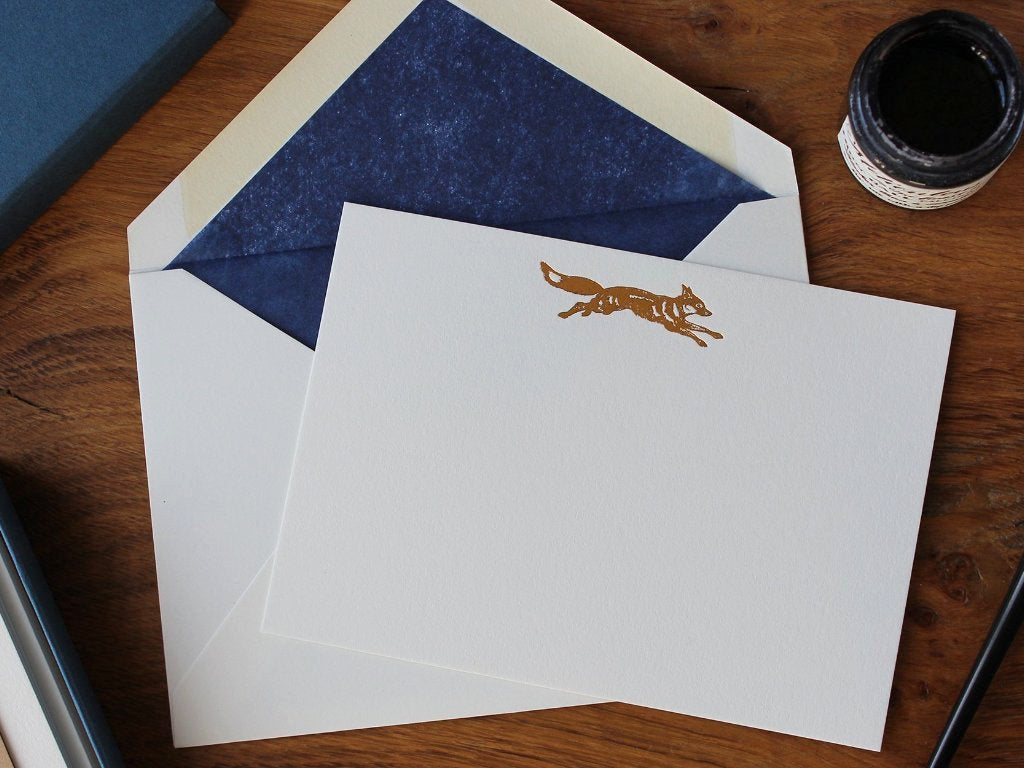 Copper Foil Fox Correspondence Card with dark blue tissue lined envelope and ink pot on wood desk