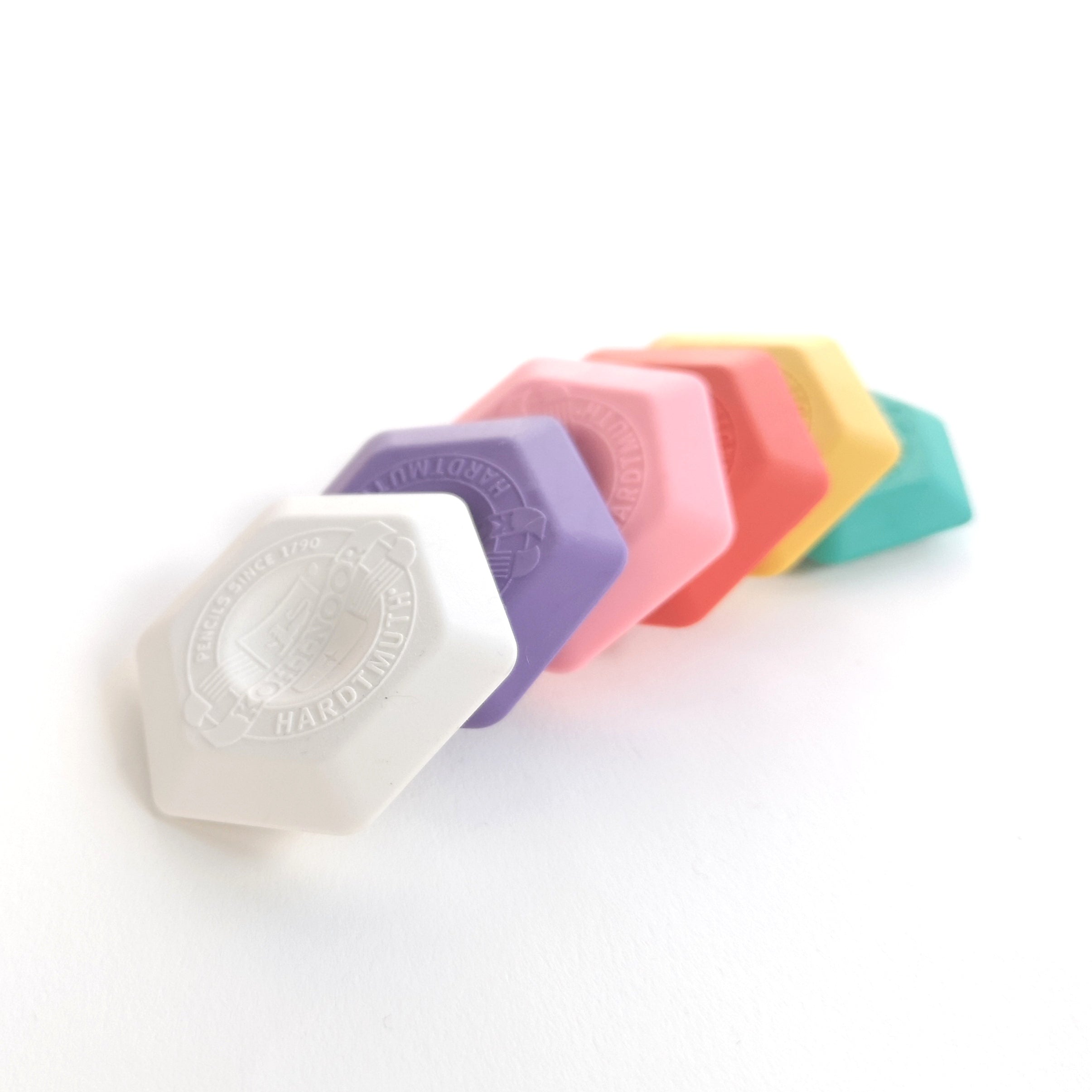 Selection of Hexagonal rubbers in white, purple, pink, red, yellow, and green