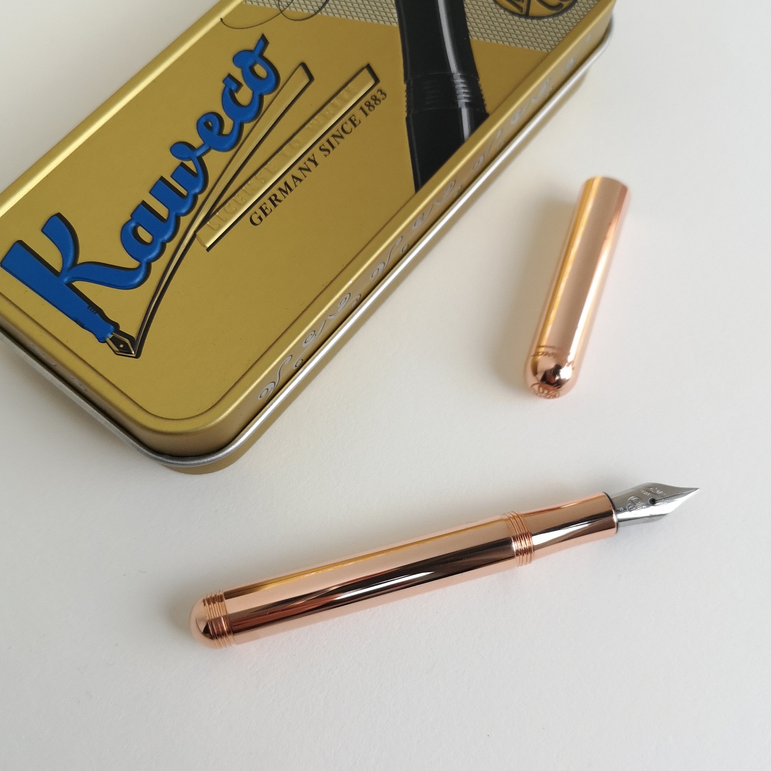 Kaweco Copper Liliput Fountain Pen with cap off and metal display tin