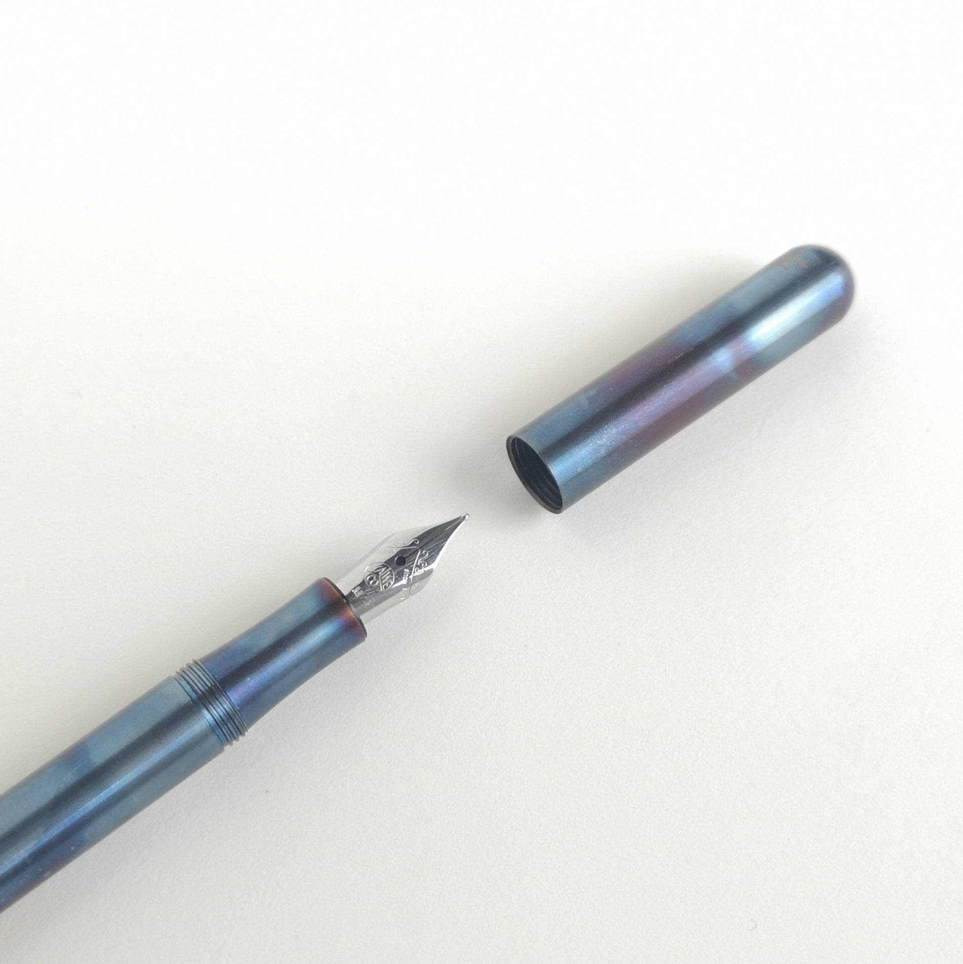 close-up of nib and cap of kaweco liliput fireblue fountain pen 