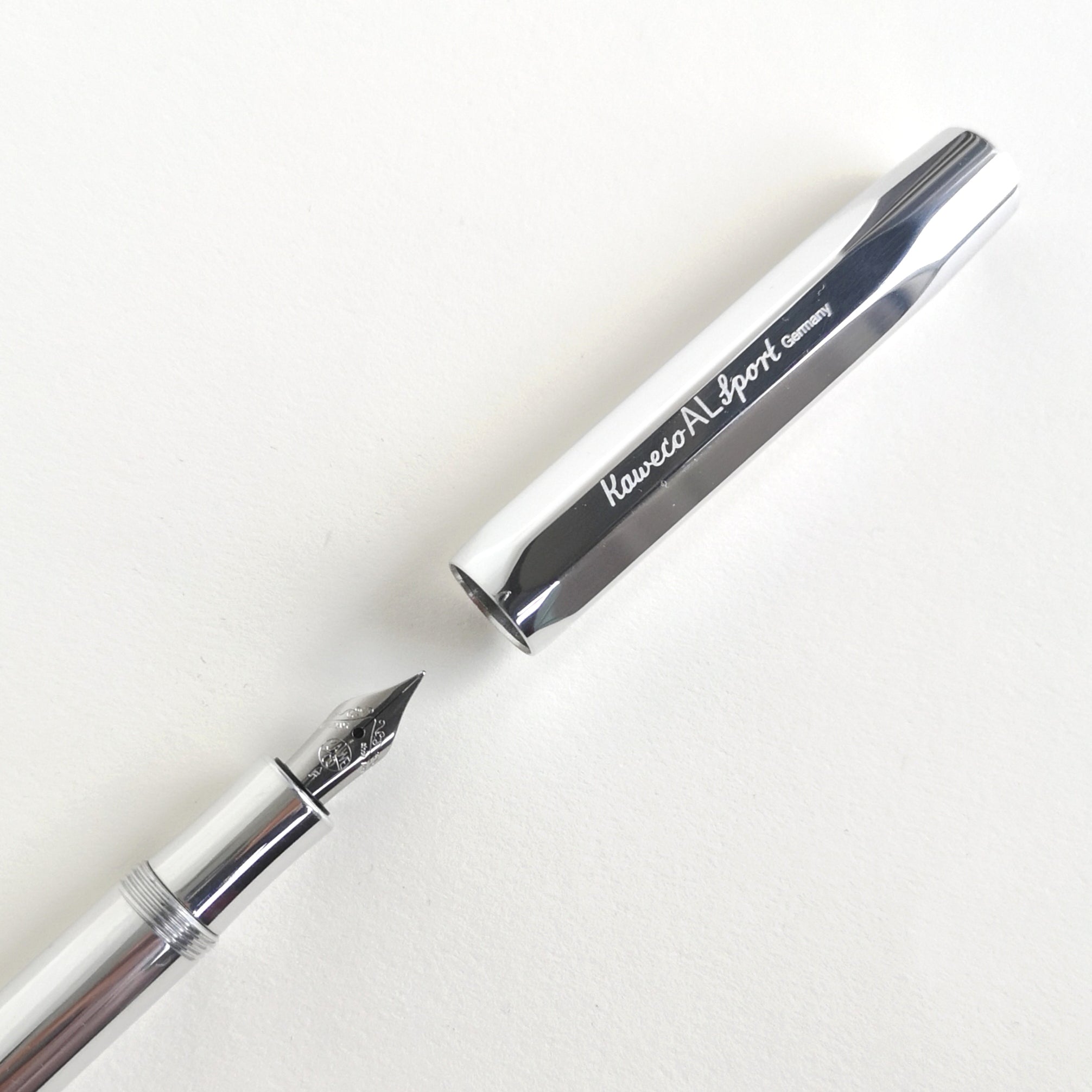Close-up of shiny silver aluminium Kaweco Sport fountain pen with cap and nib