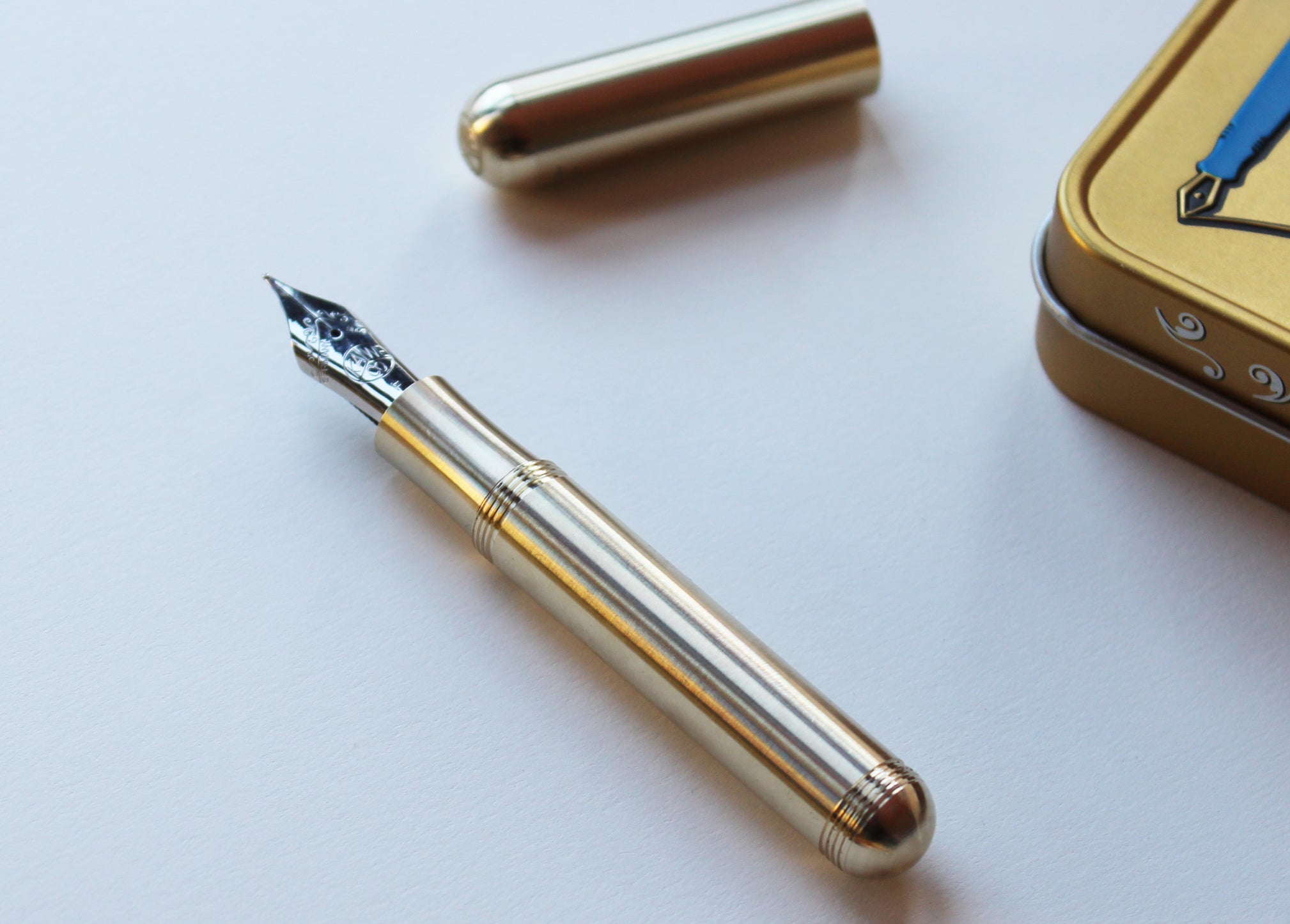 Kaweco Brass Supra Fountain Pen with cap and metal display tin to the side