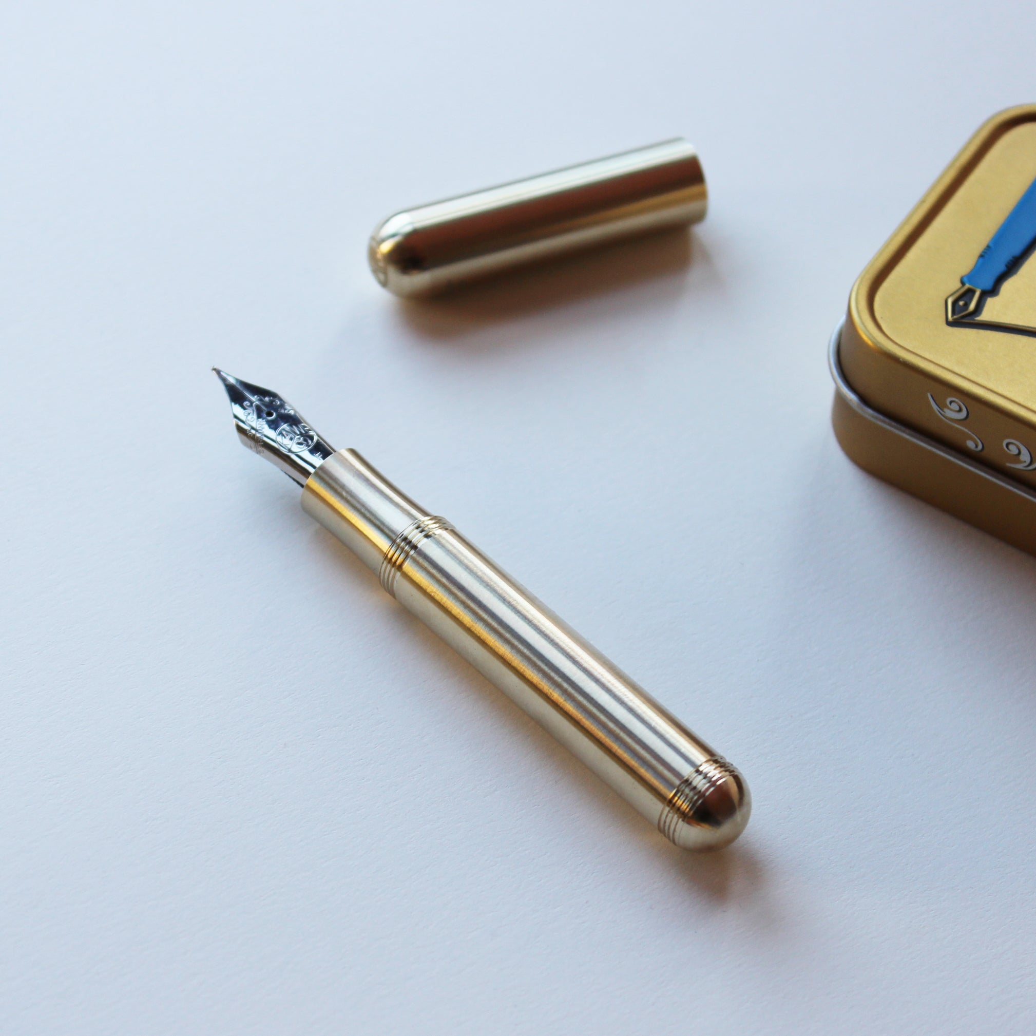 Kaweco Brass Supra Fountain Pen with cap and metal display tin to the side
