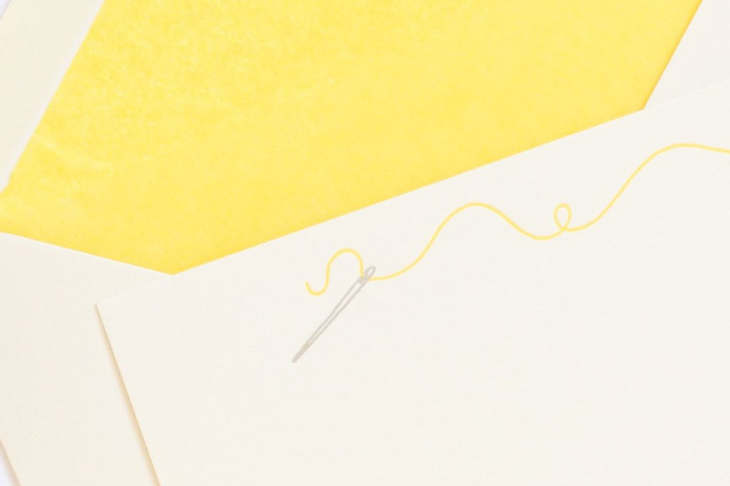Sewing Letterpress Correspondence Card with yellow thread and yellow tissue lined envelopein display box with wax seal