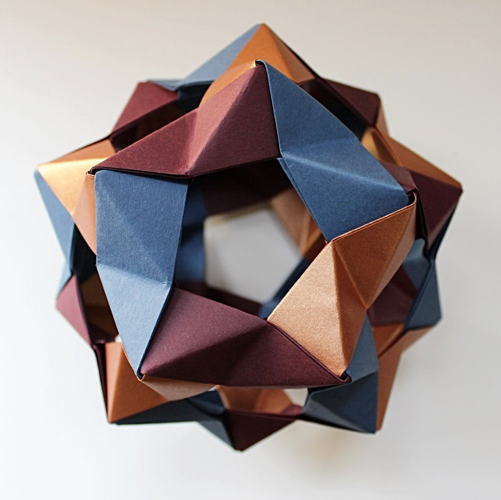 Geometric origami decoration in bronze, blue and burgundy