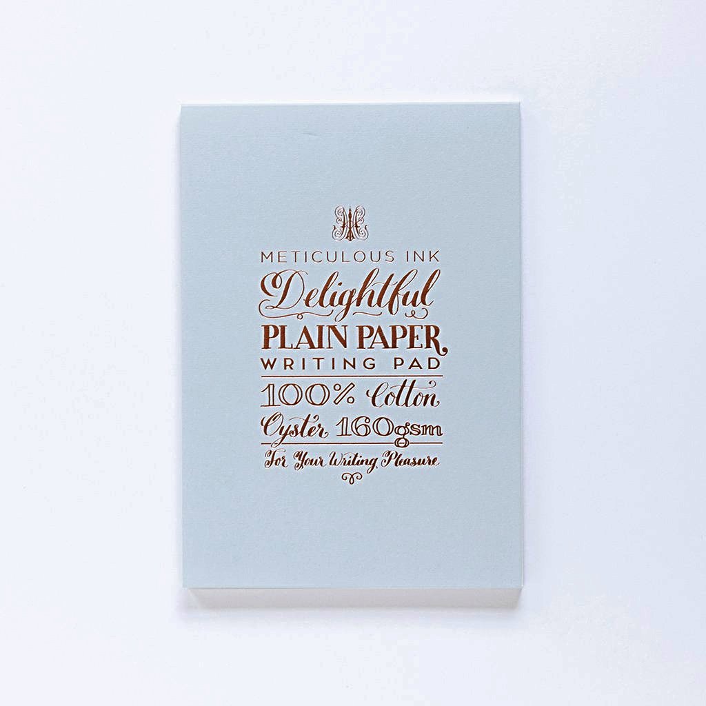 Plain writing pad with pale blue cover and gold foil