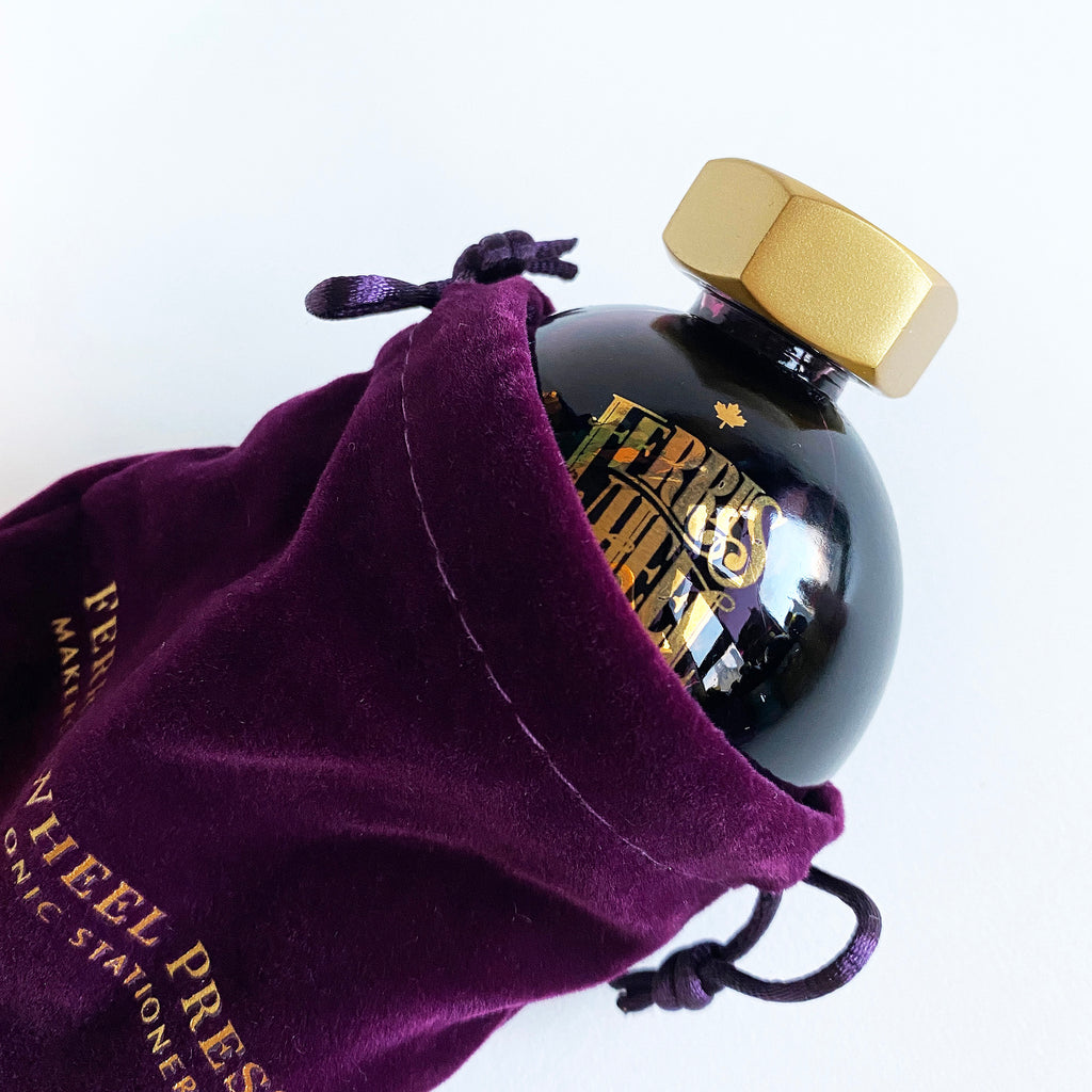 Glass ink pot in purple velvet bag